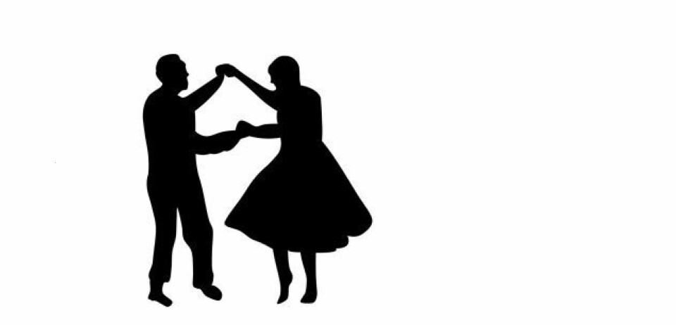 En svart silhuett av en mann og ei kvinne som danser swing
