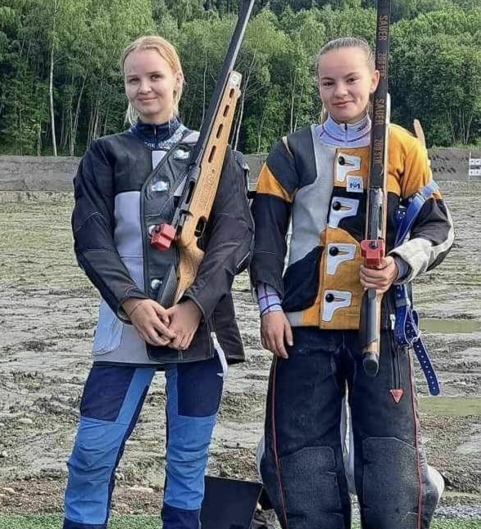 To jenter med skytterantrekk og rifler.