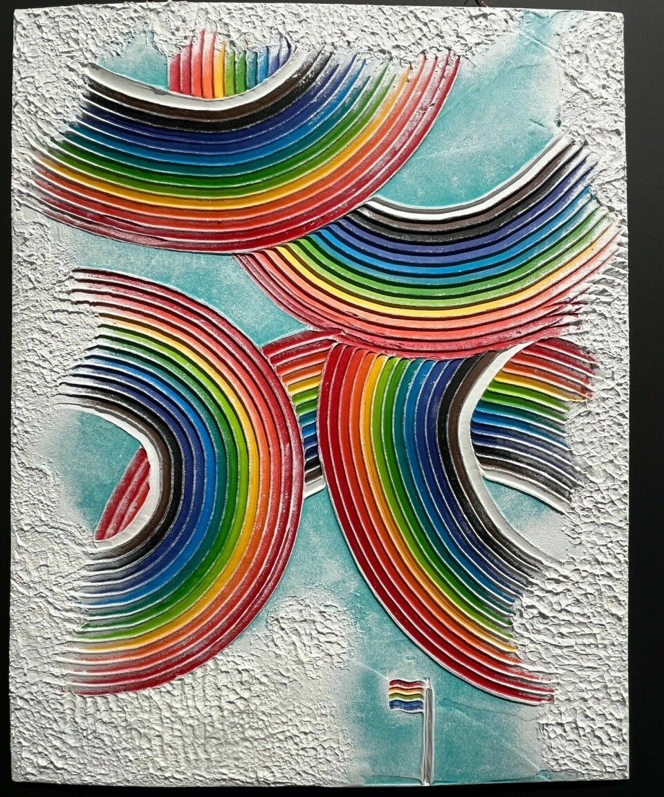 Et fargerikt maleri av regnbuer og et regnbueflagg.