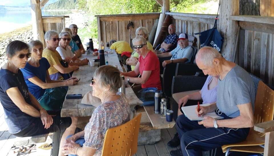 I gapahuken. Flere turgåere som tar en rast inne i en stor gapahuk med bord og benker.