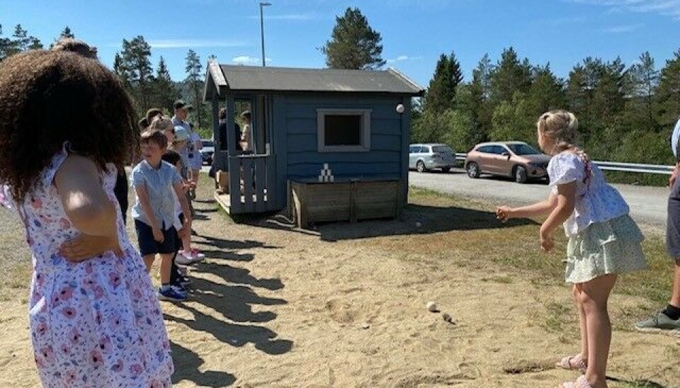 Kasting på blikkboks. barn kaster på blikkboks