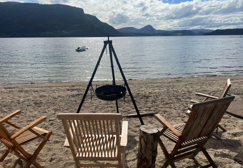 Nordvik. bålpanne med stoler rundt foran sjø