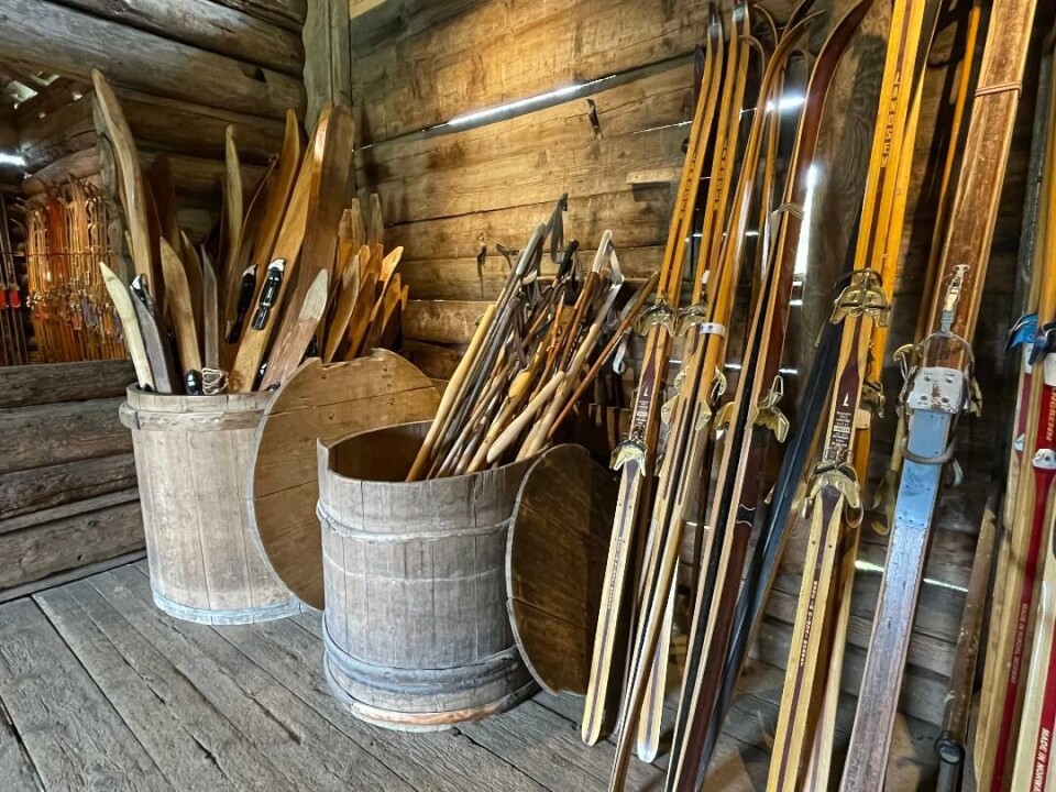 Alle gode ting er tre. Her er det mange treski og trestaver i hver sin tretønne. Mange treski og trestaver i hver sin tretønne. Også ski inntil veggen ved siden av.