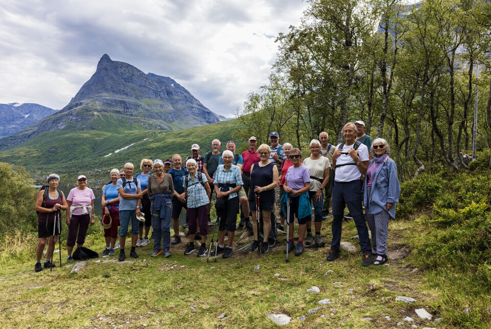 Nesten heile turgruppa samla her på heimturen Stor gruppe mennesker samlet med fjell i bakgrunnen