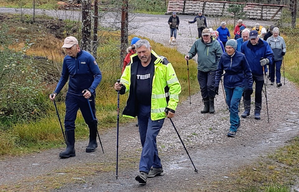 Stavgangtur til Krokvatnet 4. september Flere turkledde personer som går på en grusvei. Noen av dem med gåstaver.