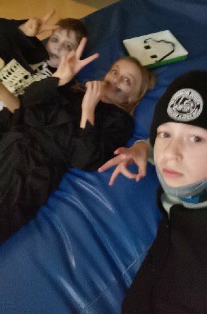 Sivert Magnus, Magnhild og Trond hadde en trivelig kveld på Mo. Tre barn som ligger på en blå tjukkas og gjør peace-tegn