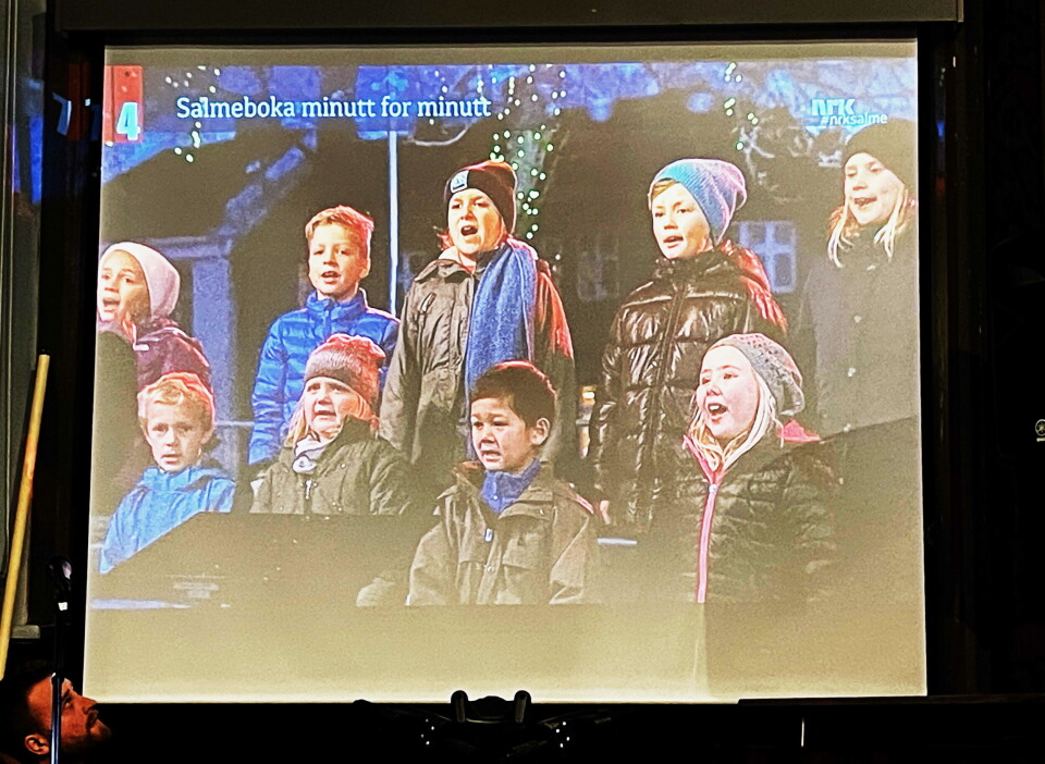 Artig gjensyn på lerretet med Amigos på Salme-TV i 2014. Bilde av en stor skjerm, som viser et barnekor med barn i yttertøy, som synger.