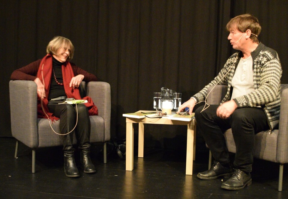 Kari Gåsvatn og Svein Sæter i samtale på scenen. Ei dame og en mann som sitter i hver sin stol på en scene.