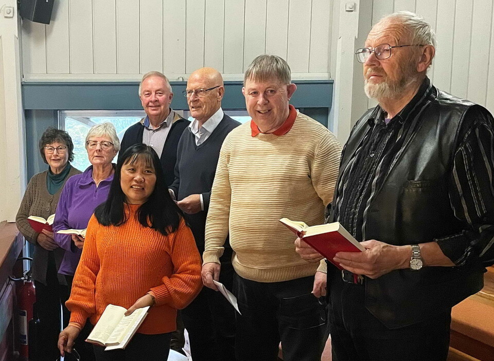 Forsongargruppene gjer stor innsats og løftar salmesongen bokstaveleg. Her gruppe i Øye kyrkje. Sju personer som står med salmebøker og synger.