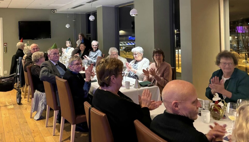 Gjestene var godt fornøyde med den vellykkede nyttårsfesten! folk rundt langbord