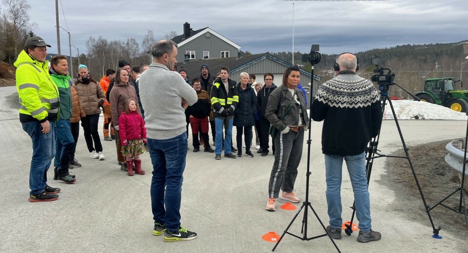Mange hadde møtt om til en liten protest-aksjon ved Lomundsjø denne kvelden. John J. Storholt ved kamera. Ei gruppe mennesker rundt et filmkamera på en veg.