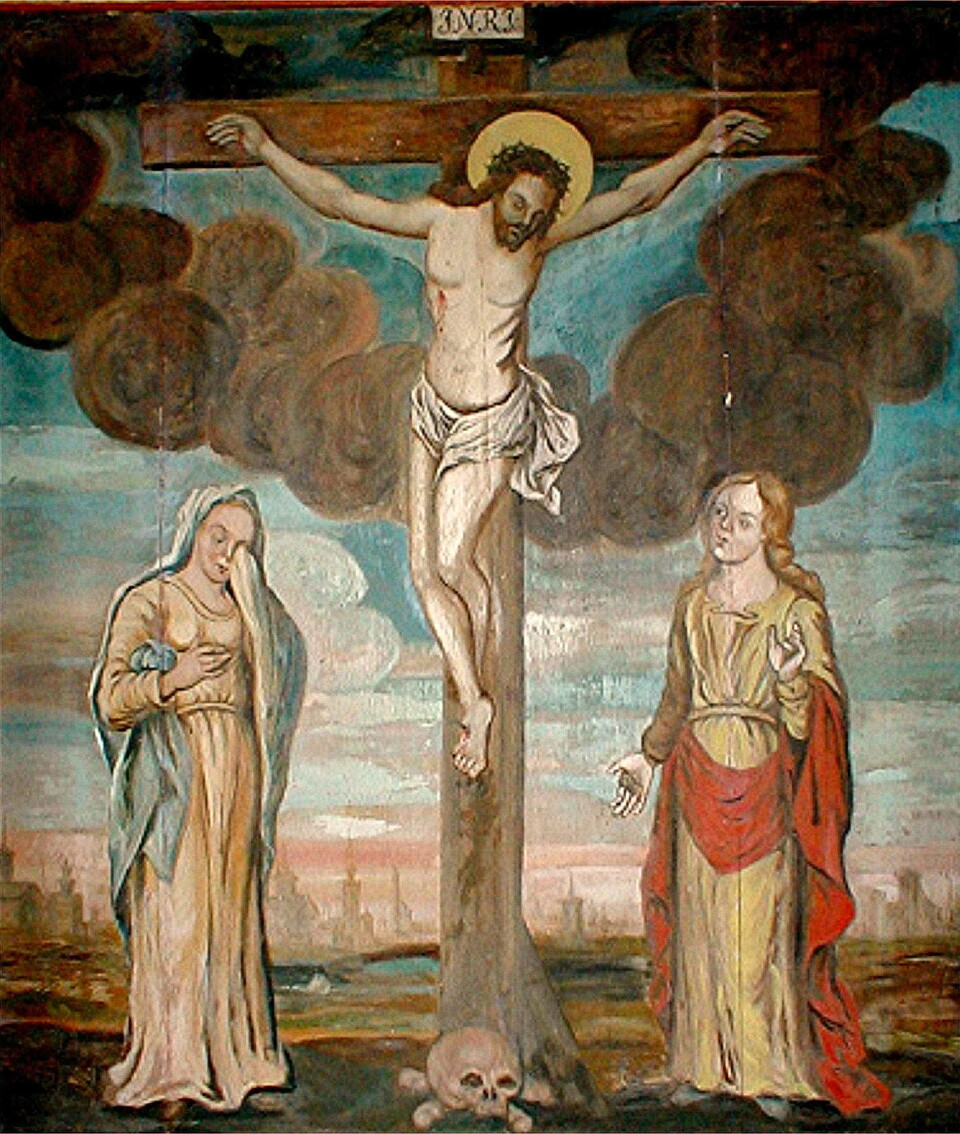 Presten Hans Bernhoft gav denne tavla til den førre Ranes-kyrkja (bygd i 1702). Bilde av maleri av Jesus på korset med to kviner ved siden av