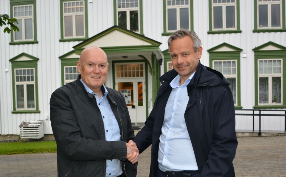 Magne Bjørnstad og Knut Marius Skoglund foran det gamle bankbygget i Rindal sentrum (nå Kommunehus 1) som ble tatt i bruk i 1914. Dette var Rindal Sparebanks lokaler fram til 1972. To menn som tar hverandre i handa.