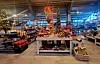 Innendørs butikk med en stor utstilling av julepynt i rødt og gull.